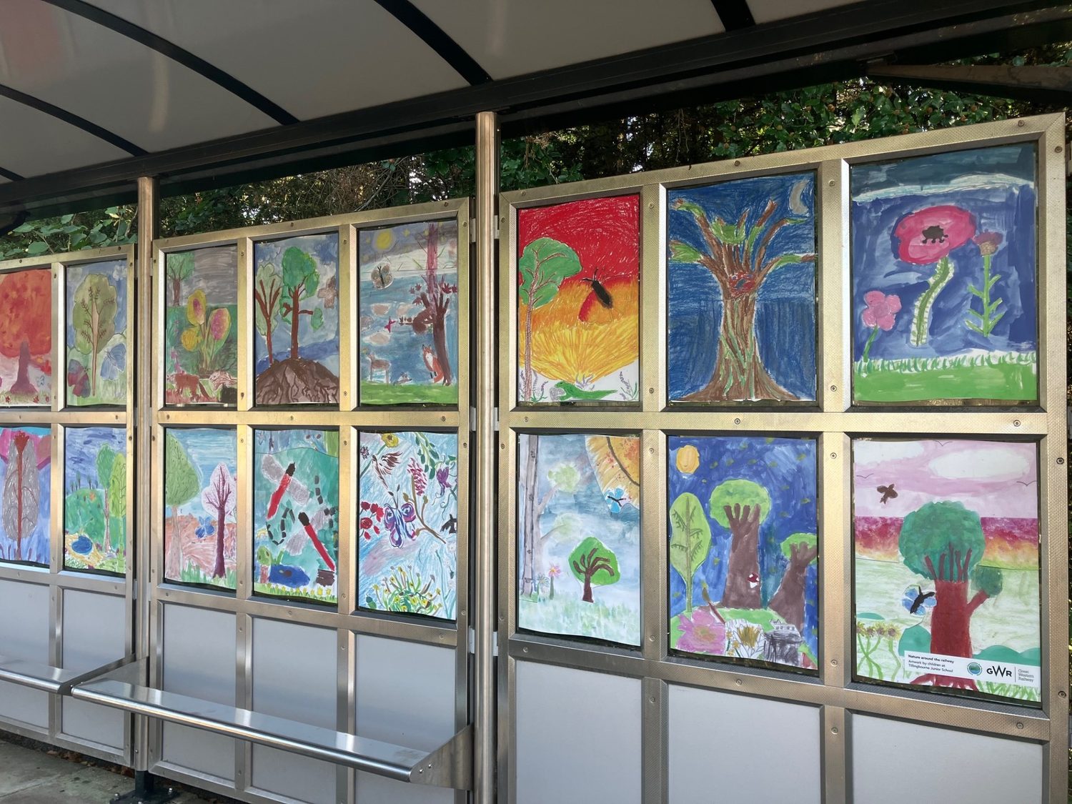 Paintings of trees, butterflies and a dragonfly along the shelter windows