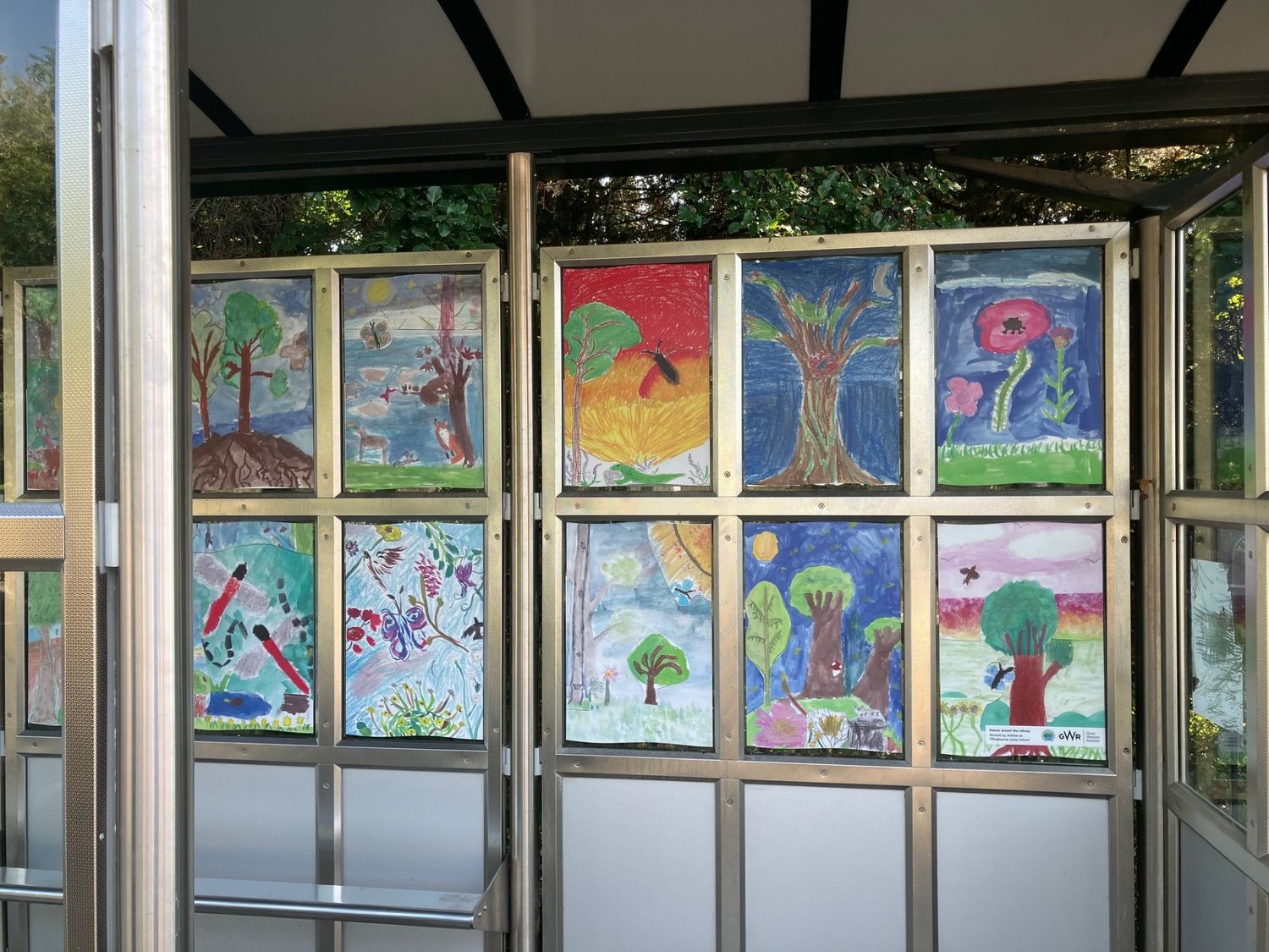 A long view of the artwork panels running the length of the platform shelter