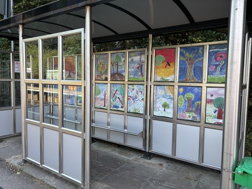 Children's paintings displayed in the shelter at Chilworth Station